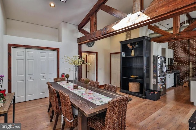 517 W Burke St, Easton, PA 18042 - dining space with light wood-type flooring, a high ceiling, and brick wall
