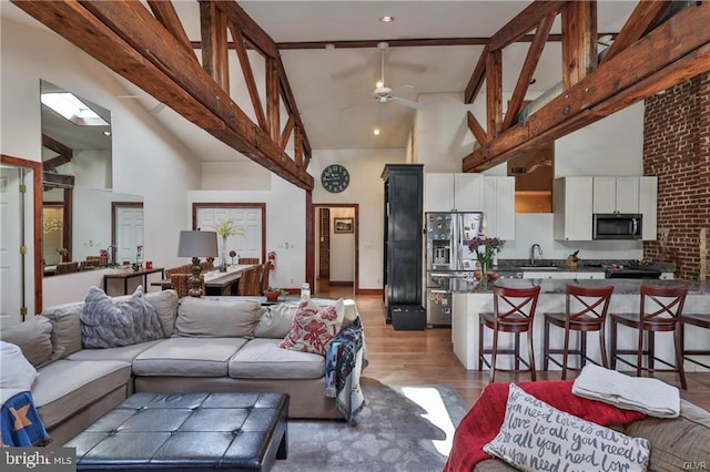 517 W Burke St, Easton, PA 18042 - living room with high vaulted ceiling, a ceiling fan, light wood finished floors, and beamed ceiling