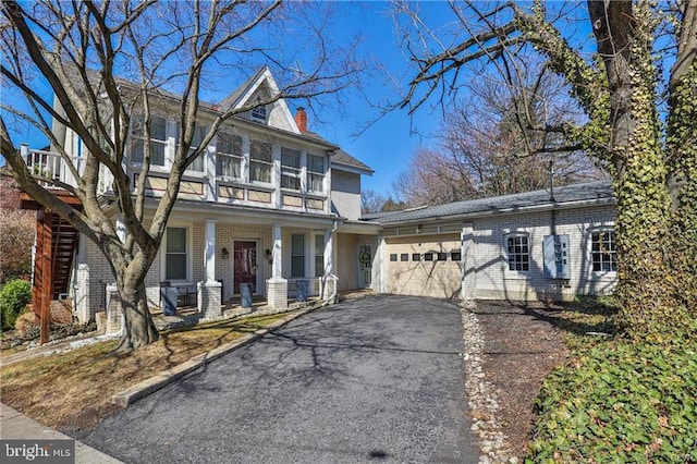 517 W Burke St, Easton, PA 18042 - view of front of house with brick siding, a porch, a garage, and asphalt driveway