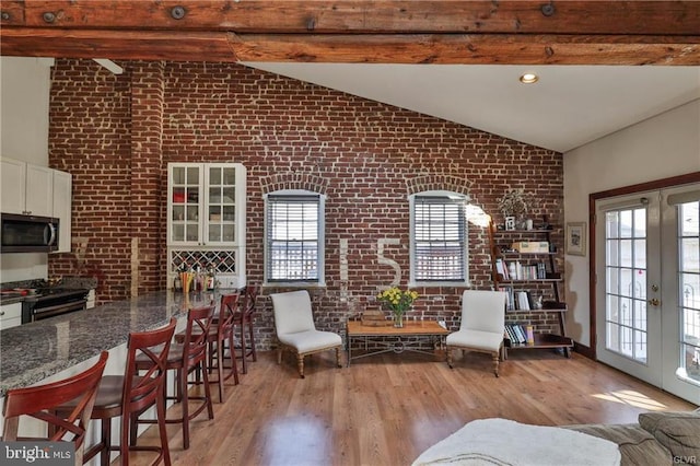 517 W Burke St, Easton, PA 18042 - living room with brick wall, healthy amount of natural light, light wood-style floors, and french doors