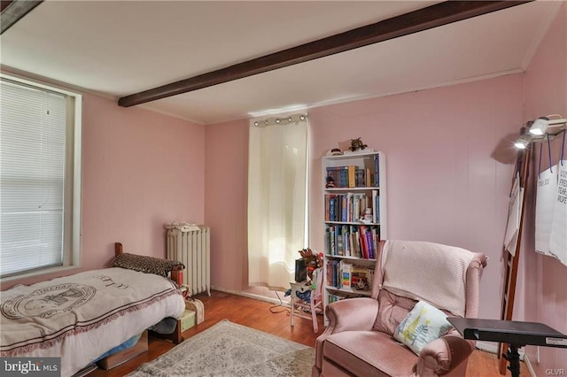 517 W Burke St, Easton, PA 18042 - bedroom with radiator heating unit, wood finished floors, beam ceiling, ornamental molding, and multiple windows