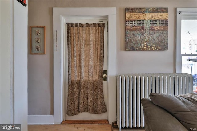 517 W Burke St, Easton, PA 18042 - doorway to outside featuring radiator heating unit and wood finished floors