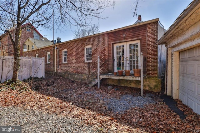 517 W Burke St, Easton, PA 18042 - view of side of home with brick siding, french doors, and a garage