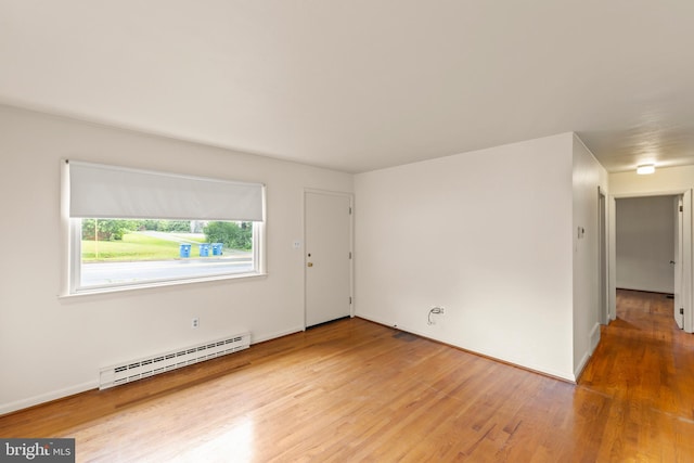 311 S Buckmarsh St, Berryville, VA 22611 - empty room with a baseboard heating unit and wood finished floors