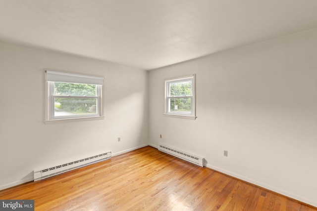 311 S Buckmarsh St, Berryville, VA 22611 - spare room with a baseboard heating unit, light wood finished floors, and baseboards