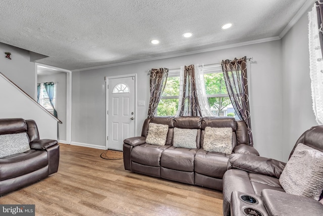 113 Tremont St, Manassas Park, VA 20111 - living area with light wood finished floors, a textured ceiling, ornamental molding, recessed lighting, and baseboards