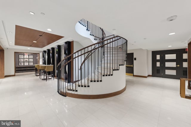 616 E St NW Unit 1114, Washington, DC 20004 - stairs with baseboards, a raised ceiling, tile patterned flooring, and recessed lighting