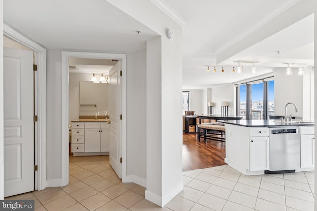 616 E St NW Unit 1114, Washington, DC 20004 - kitchen featuring dishwasher, a sink, light tile patterned floors, white cabinets, and crown molding