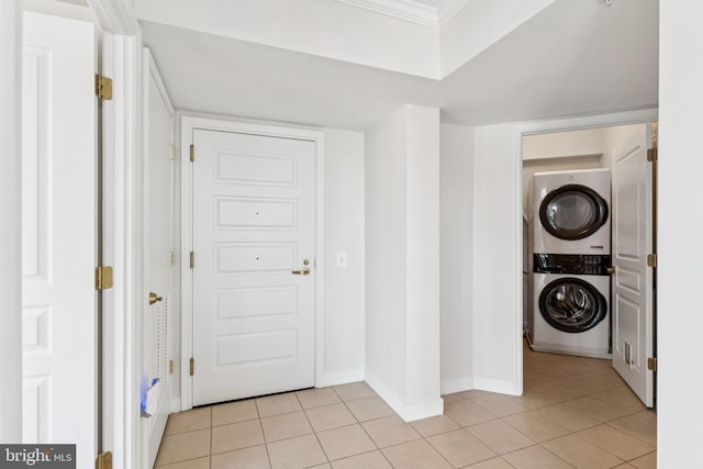 616 E St NW Unit 1114, Washington, DC 20004 - laundry room with estacked washer and dryer, light tile patterned flooring, baseboards, and ornamental molding