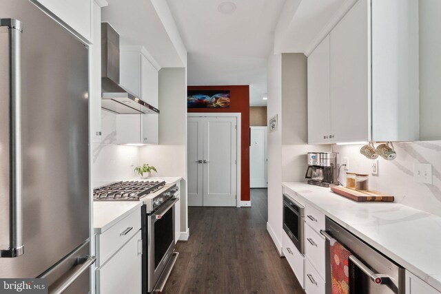 625 Slaters Ln Unit 201, Alexandria, VA 22314 - kitchen with appliances with stainless steel finishes, wall chimney range hood, beverage cooler, white cabinetry, and light countertops