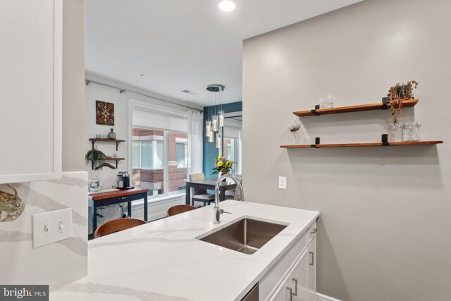 625 Slaters Ln Unit 201, Alexandria, VA 22314 - kitchen with a sink, white cabinetry, light stone countertops, open shelves, and recessed lighting