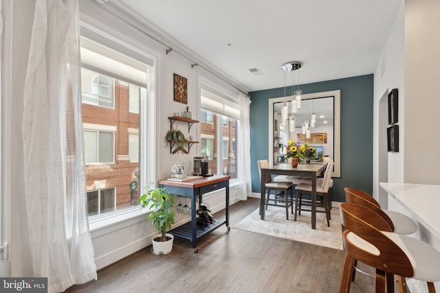 625 Slaters Ln Unit 201, Alexandria, VA 22314 - dining space with dark wood-style flooring, baseboards, and a chandelier