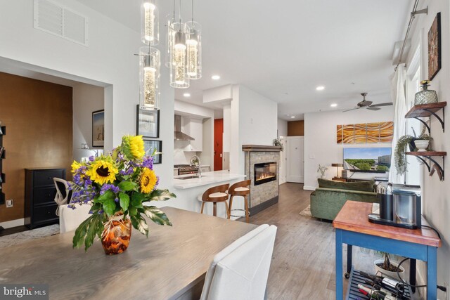 625 Slaters Ln Unit 201, Alexandria, VA 22314 - dining area with recessed lighting, a glass covered fireplace, wood finished floors, ceiling fan, and baseboards