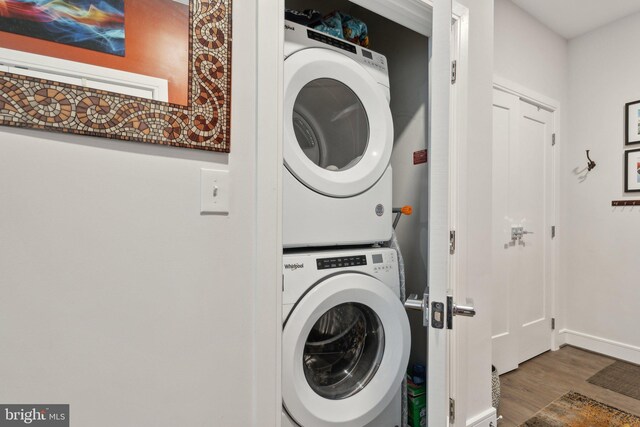 625 Slaters Ln Unit 201, Alexandria, VA 22314 - laundry room with estacked washer and dryer, wood finished floors, and baseboards