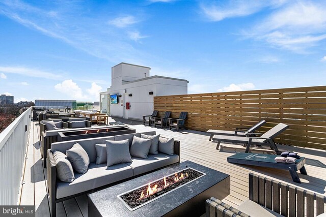 625 Slaters Ln Unit 201, Alexandria, VA 22314 - deck with an outdoor living space with a fire pit