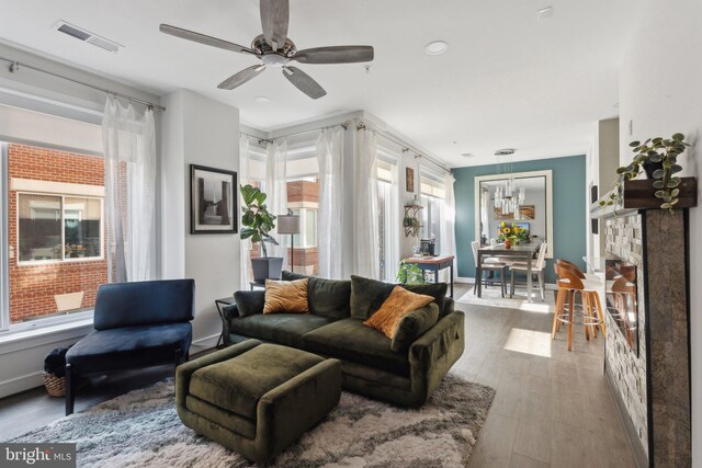 625 Slaters Ln Unit 201, Alexandria, VA 22314 - living room featuring a ceiling fan, wood finished floors, recessed lighting, a chandelier, and baseboards