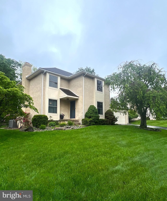 25 Hayloft Cir, Wilmington, DE 19808 - traditional-style house featuring a chimney, stucco siding, a front lawn, central AC, and a garage