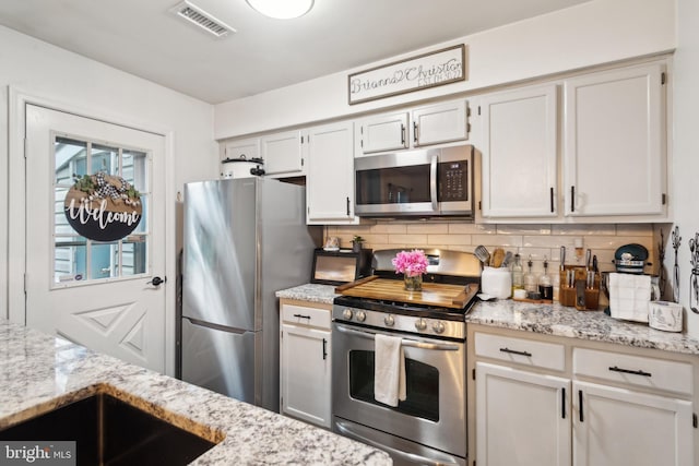 603 Lindsley Ct, Burlington, NJ 08016 - kitchen featuring stainless steel appliances, tasteful backsplash, and light stone counters
