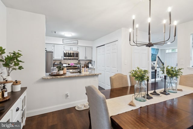 603 Lindsley Ct, Burlington, NJ 08016 - dining space featuring a chandelier, dark wood-style flooring, stairs, and baseboards