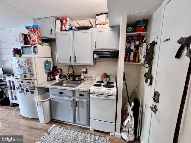 11 62nd St Unit 212, Ocean City, MD 21842 - kitchen with white appliances, a sink, under cabinet range hood, light wood-style flooring, and light countertops