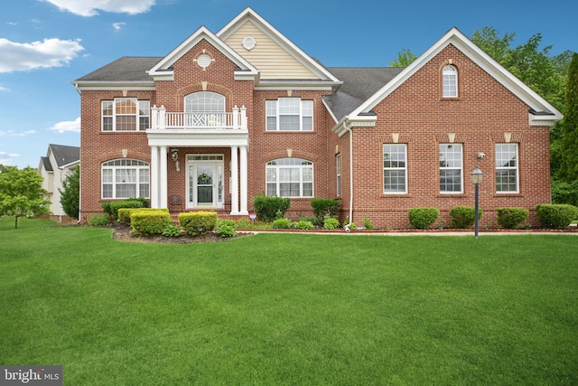 14201 Village Manor Ct, Upper Marlboro, MD 20774 - colonial house with a balcony, a front yard, and brick siding