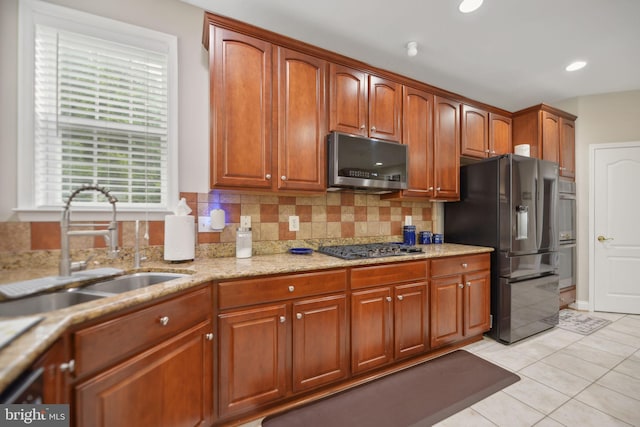 14201 Village Manor Ct, Upper Marlboro, MD 20774 - kitchen with stainless steel microwave, refrigerator with ice dispenser, a sink, backsplash, and light tile patterned floors