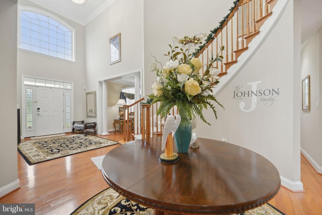 14201 Village Manor Ct, Upper Marlboro, MD 20774 - foyer entrance featuring stairs, crown molding, baseboards, wood finished floors, and a high ceiling