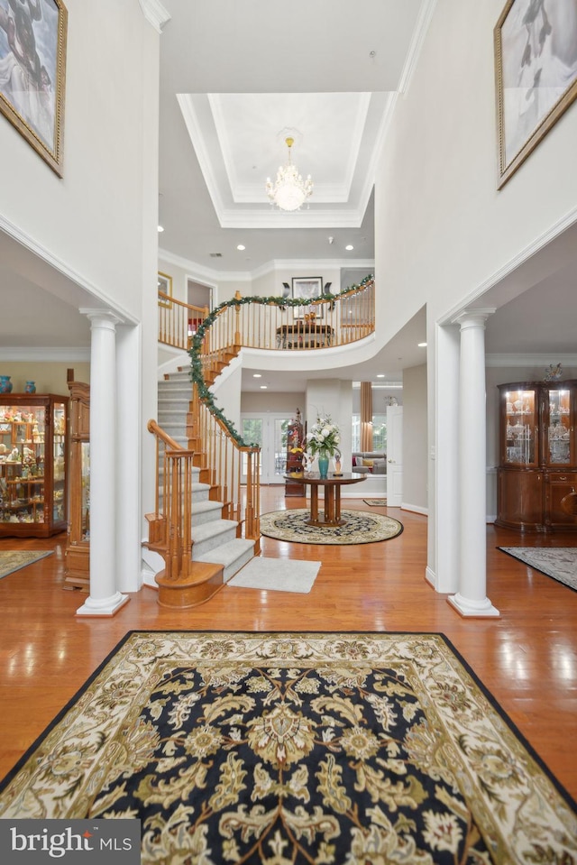 14201 Village Manor Ct, Upper Marlboro, MD 20774 - entryway featuring ornate columns, a towering ceiling, wood finished floors, crown molding, and stairway