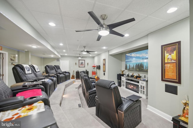 14201 Village Manor Ct, Upper Marlboro, MD 20774 - carpeted living area featuring a ceiling fan, a warm lit fireplace, recessed lighting, a drop ceiling, and baseboards