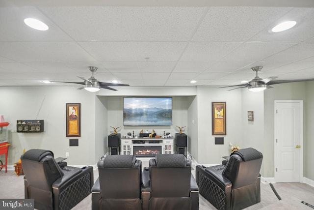 14201 Village Manor Ct, Upper Marlboro, MD 20774 - carpeted home theater with a ceiling fan, a paneled ceiling, baseboards, a warm lit fireplace, and recessed lighting