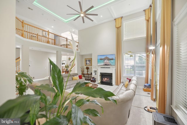 14201 Village Manor Ct, Upper Marlboro, MD 20774 - living area with a towering ceiling, ceiling fan, a warm lit fireplace, and stairway