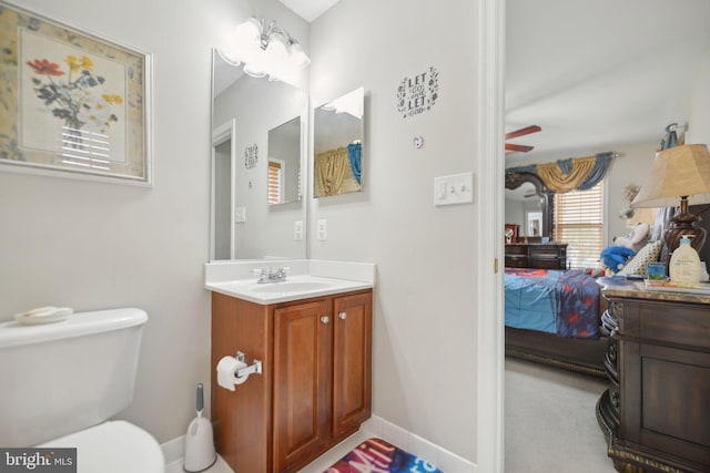 14201 Village Manor Ct, Upper Marlboro, MD 20774 - bathroom with connected bathroom, vanity, toilet, and baseboards