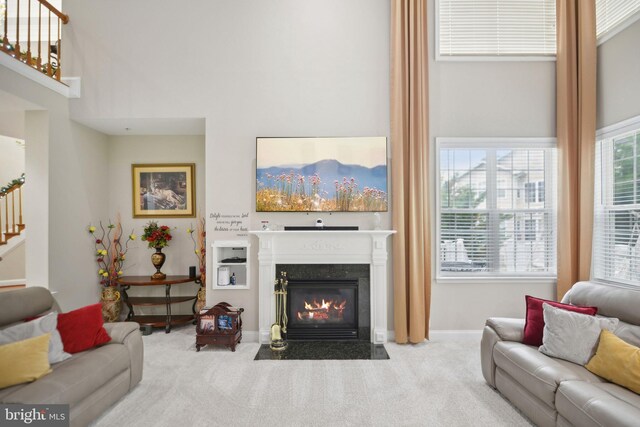 14201 Village Manor Ct, Upper Marlboro, MD 20774 - living area featuring carpet floors, a fireplace with flush hearth, stairway, and baseboards
