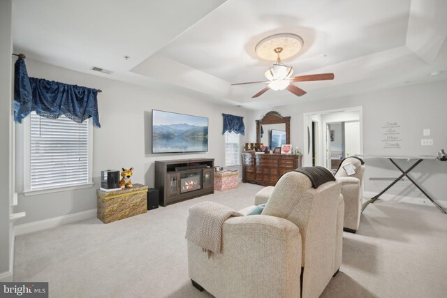 14201 Village Manor Ct, Upper Marlboro, MD 20774 - living area with a raised ceiling, carpet, baseboards, and ceiling fan