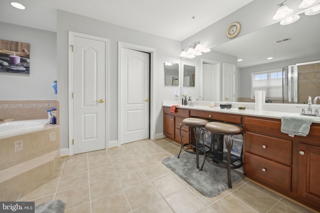 14201 Village Manor Ct, Upper Marlboro, MD 20774 - full bathroom with tile patterned floors, a garden tub, double vanity, a shower with door, and baseboards