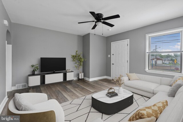 218 Center Ave, Mount Ephraim, NJ 08059 - living room featuring wood finished floors, arched walkways, a ceiling fan, and baseboards