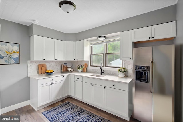 218 Center Ave, Mount Ephraim, NJ 08059 - kitchen featuring stainless steel refrigerator with ice dispenser, a sink, light wood-type flooring, light countertops, and tasteful backsplash
