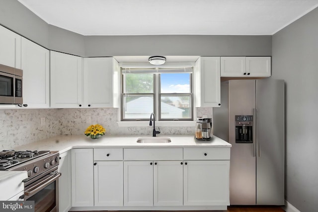 218 Center Ave, Mount Ephraim, NJ 08059 - kitchen with stainless steel appliances, a sink, white cabinets, decorative backsplash, and light countertops