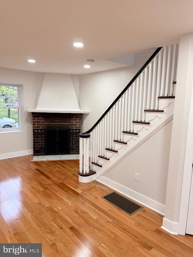 114 Marshall Rd, Lansdowne, PA 19050 - stairway featuring wood finished floors, baseboards, recessed lighting, and a fireplace