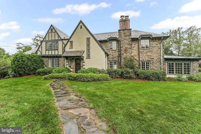 1201 Grenox Rd, Wynnewood, PA 19096 - rear view of house with stone siding, stucco siding, and a lawn
