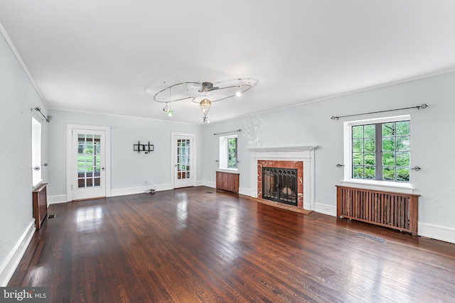 1201 Grenox Rd, Wynnewood, PA 19096 - unfurnished living room featuring radiator, wood finished floors, a fireplace, baseboards, and crown molding