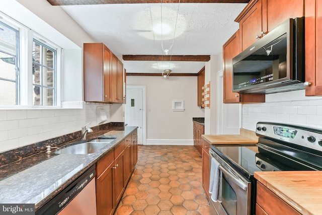 1201 Grenox Rd, Wynnewood, PA 19096 - kitchen with appliances with stainless steel finishes, a sink, brown cabinetry, and a textured ceiling
