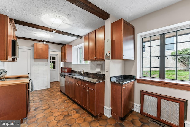 1201 Grenox Rd, Wynnewood, PA 19096 - kitchen with a textured ceiling, stainless steel appliances, a sink, backsplash, and brown cabinets
