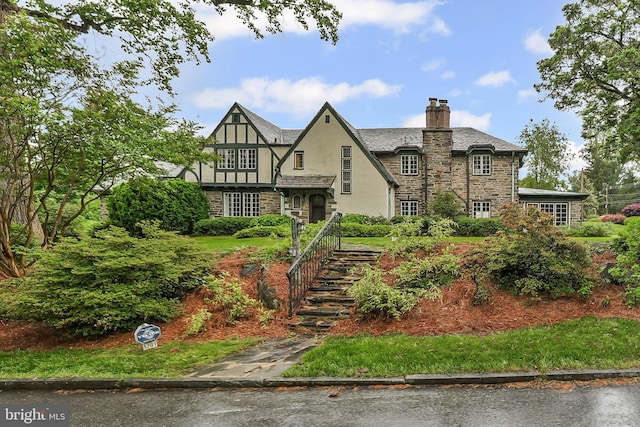 1201 Grenox Rd, Wynnewood, PA 19096 - english style home with stone siding, stucco siding, a chimney, and stairs