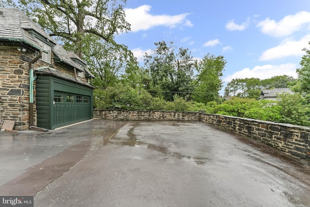 1201 Grenox Rd, Wynnewood, PA 19096 - view of patio / terrace with an attached garage and view of wooded area