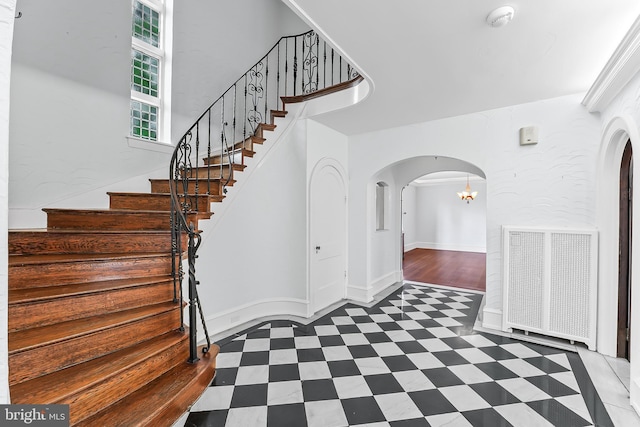 1201 Grenox Rd, Wynnewood, PA 19096 - stairway featuring arched walkways, tile patterned floors, and baseboards