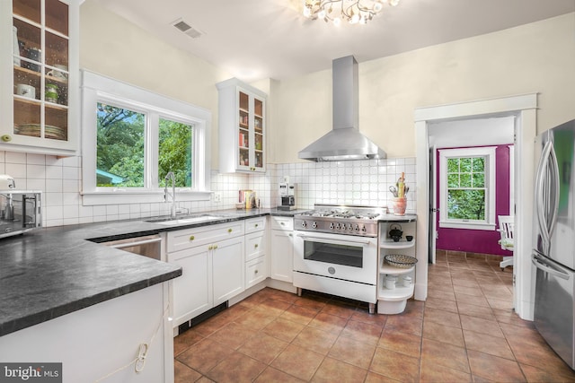 15 Jefferson Ave, Takoma Park, MD 20912 - kitchen with island exhaust hood, appliances with stainless steel finishes, a sink, and dark countertops
