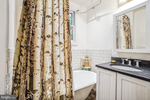 15 Jefferson Ave, Takoma Park, MD 20912 - bathroom featuring tile walls, a soaking tub, vanity, and wainscoting