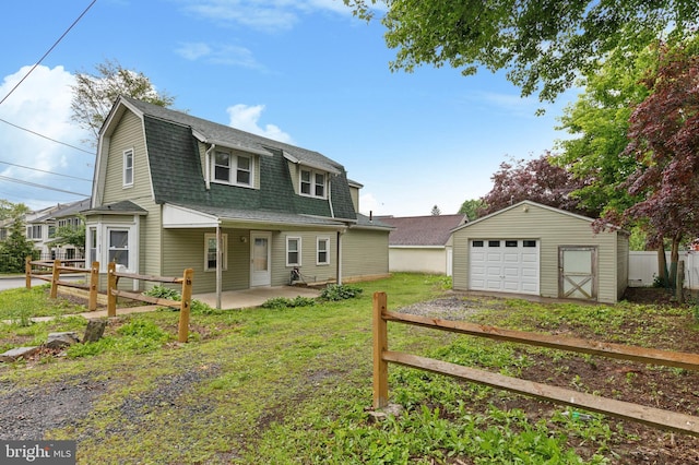 603 Vernon St, Media, PA 19063 - rear view of house with a shingled roof, a garage, an outbuilding, a gambrel roof, and driveway