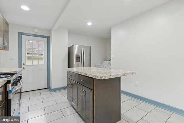 603 Vernon St, Media, PA 19063 - kitchen featuring appliances with stainless steel finishes, separate washer and dryer, light countertops, light tile patterned flooring, and recessed lighting